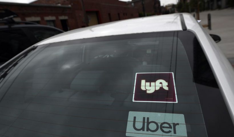 Rideshare drivers demonstrate against rideshare companies Uber and Lyft during a car caravan protest on August 6, 2020 in Los Angeles. - The drivers, organized by the Mobile Workers Alliance and Rideshare Drivers United unions, say Uber and Lyft's are pushing a "deceptive" November ballot initiative, which, if passed, they claim would "rewrite labor law" and turn app-based drivers into independent contractors, exempting companies such as Lyft and Uber from standard wage and hour restrictions. (Photo by Robyn Beck / AFP) (Photo by ROBYN BECK/AFP via Getty Images)