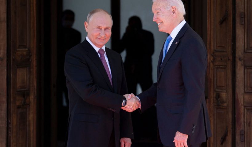 Russian President Vladimir Putin (L) shakes hands with US President Joe Biden prior to the US-Russia summit at the Villa La Grange, in Geneva on June 16, 2021. (Photo by Brendan Smialowski / AFP) (Photo by BRENDAN SMIALOWSKI/AFP via Getty Images)