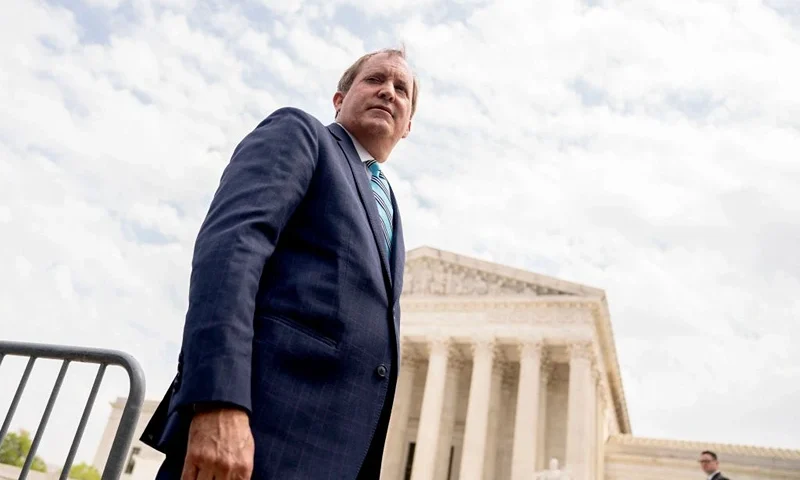 Texas Attorney General Ken Paxton speaks to reporters in front of the US Supreme Court in Washington, DC, on April 26, 2022. - The Supreme Court will hear oral arguments Tuesday in the Biden v. Texas case, which will determine if the Biden administration must continue to enforce a Trump-era program known as the remain in Mexico policy. The court is considering whether President Joe Biden can end a controversial Trump-era border policy that denies asylum-seekers entry to the US while their case is reviewed. (Photo by Stefani Reynolds / AFP) (Photo by STEFANI REYNOLDS/AFP via Getty Images)
