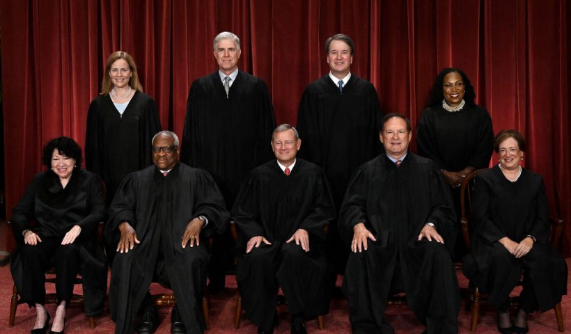 TOPSHOT - Justices of the US Supreme Court pose for their official photo at the Supreme Court in Washington, DC on October 7, 2022. (Seated from left) Associate Justice Sonia Sotomayor, Associate Justice Clarence Thomas, Chief Justice John Roberts, Associate Justice Samuel Alito and Associate Justice Elena Kagan, (Standing behind from left) Associate Justice Amy Coney Barrett, Associate Justice Neil Gorsuch, Associate Justice Brett Kavanaugh and Associate Justice Ketanji Brown Jackson. (Photo by OLIVIER DOULIERY / AFP) (Photo by OLIVIER DOULIERY/AFP via Getty Images)