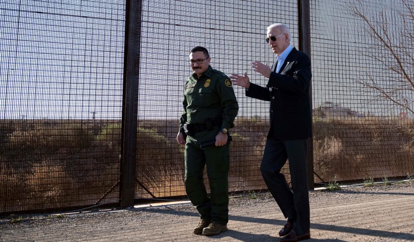 US President Joe Biden (L) speaks with a member of the US Border Patrol as they walk along the US-Mexico border fence in El Paso, Texas, on January 8, 2023. - Biden went to the US-Mexico border on Sunday for the first time since taking office, visiting an El Paso, Texas entry point at the center of debates over illegal immigration and smuggling. (Photo by Jim WATSON / AFP) (Photo by JIM WATSON/AFP via Getty Images)