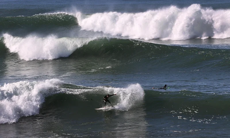 SAN DIEGO, CALIFORNIA - JANUARY 11: A surfer rides large waves that pound the San Diego coastline, closing piers and prompting high surf advisories along city beaches on January 11, 2021 in San Diego, California. The high surf advisories are in effect until mid-day January 12, 2021. (Photo by Sean M. Haffey/Getty Images)
