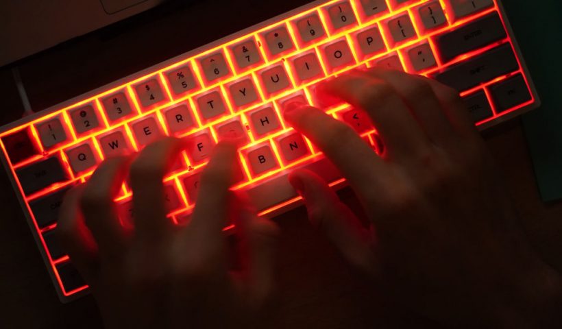 BERLIN, GERMANY - JANUARY 25: In this photo illustration a young man types on an illuminated computer keyboard typically favored by computer coders on January 25, 2021 in Berlin, Germany. 2020 saw a sharp rise in global cybercrime that was in part driven by the jump in online retailing that ensued during national lockdowns as governments sought to rein in the coronavirus pandemic. (Photo by Sean Gallup/Getty Images)