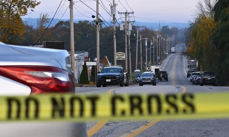 US-CRIME-SHOOTING Police tape blocks off the street near Schemengees Bar and Grille in Lewiston, Maine, on October 27, 2023, in the aftermath of a mass shooting. Hundreds of police in the US state of Maine hunted October 26, 2023 for a fugitive gunman who killed 18 people at a bowling alley and a bar, as President Joe Biden mourned "yet another senseless and tragic mass shooting." Police named the suspect as 40-year-old Robert Card -- seen in surveillance footage pointing a semi-automatic rifle as he walked into the Sparetime Recreation bowling alley. (Photo by ANGELA WEISS / AFP) (Photo by ANGELA WEISS/AFP via Getty Images)