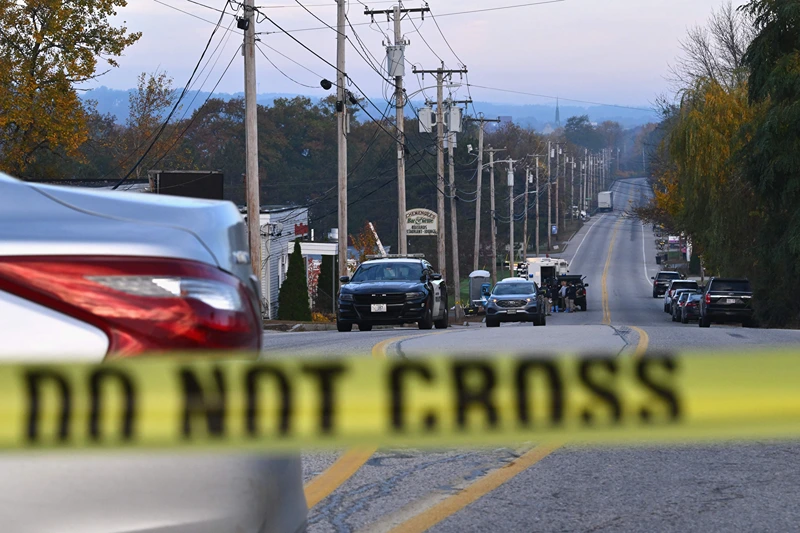 US-CRIME-SHOOTING
Police tape blocks off the street near Schemengees Bar and Grille in Lewiston, Maine, on October 27, 2023, in the aftermath of a mass shooting. Hundreds of police in the US state of Maine hunted October 26, 2023 for a fugitive gunman who killed 18 people at a bowling alley and a bar, as President Joe Biden mourned "yet another senseless and tragic mass shooting." Police named the suspect as 40-year-old Robert Card -- seen in surveillance footage pointing a semi-automatic rifle as he walked into the Sparetime Recreation bowling alley. (Photo by ANGELA WEISS / AFP) (Photo by ANGELA WEISS/AFP via Getty Images)