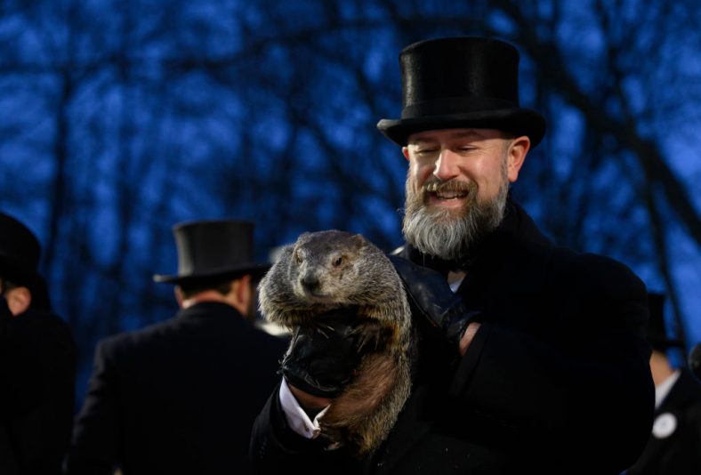 PUNXSUTAWNEY, PA - FEBRUARY 2: Groundhog handler AJ Dereume holds Punxsutawney Phil after he did not see his shadow predicting an early Spring during the 138th annual Groundhog Day festivities on Friday February 2, 2024 in Punxsutawney, Pennsylvania. Groundhog Day is a popular tradition in the United States and Canada. Over 40,000 people spent a night of revelry awaiting the sunrise and the groundhog's exit from his winter den. If Punxsutawney Phil sees his shadow he regards it as an omen of six more weeks of bad weather and returns to his den. Early spring arrives if he does not see his shadow, causing Phil to remain above ground. (Photo by Jeff Swensen/Getty Images)