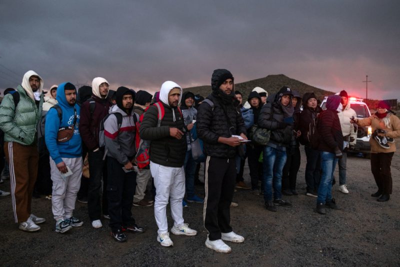 Asylum seekers wait in line to be processed by the Border Patrol at a makeshift camp near the US-Mexico border east of Jacumba, San Diego County, California, January 2, 2024. (Photo by Guillermo Arias / AFP) (Photo by GUILLERMO ARIAS/AFP via Getty Images)
