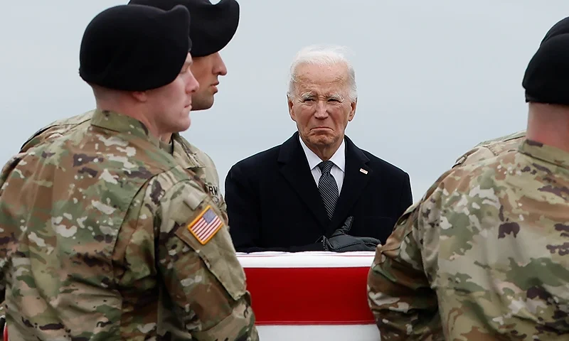 DOVER, DELAWARE - FEBRUARY 02: U.S. President Joe Biden places his hand over his heart as a U.S. Army carry team moves a flagged draped transfer case containing the remains of Army Sgt. Breonna Moffett during a dignified transfer at Dover Air Force Base on February 02, 2024 in Dover, Delaware. U.S. Army Sgt. William Rivers, Sgt. Breonna Moffett, Sgt. Kennedy Sanders were killed in addition to 40 other troops were injured during a drone strike in Jordan. (Photo by Kevin Dietsch/Getty Images)