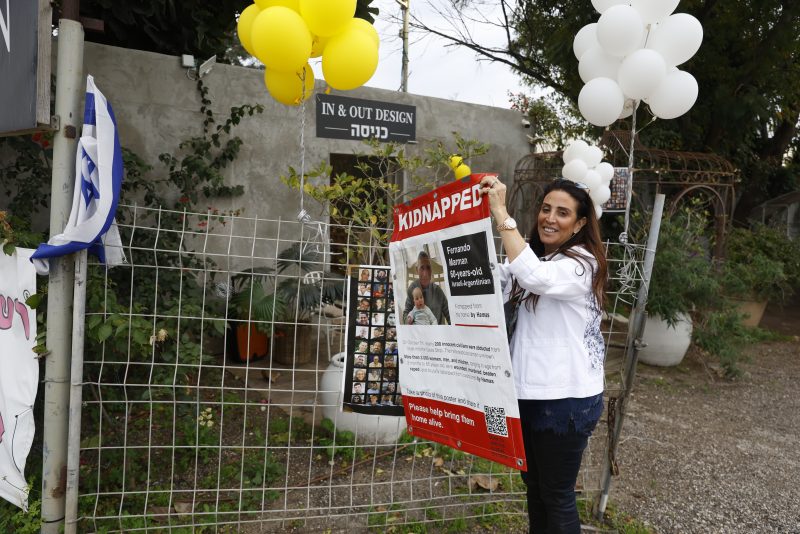 TEL AVIV, ISRAEL - FEBRUARY 12: Hagit Matzliah takes off a kidnapped sign from the store where rescued hostage, Fernando Marman, worked in Ramat Hasharon on February 12, 2024 in Tel Aviv, Israel. The Israeli military says it has rescued two hostages from captivity in Rafah, whilst two 21-year old IDF soldiers were killed in overnight fighting in the Gaza Strip. The IDF has now rescued three hostages through military operations since Oct. 7, as PM Netanyahu faces pressure from relatives of freed hostages to secure the release of the remaining captives through negations with Hamas. (Photo by Amir Levy/Getty Images)
