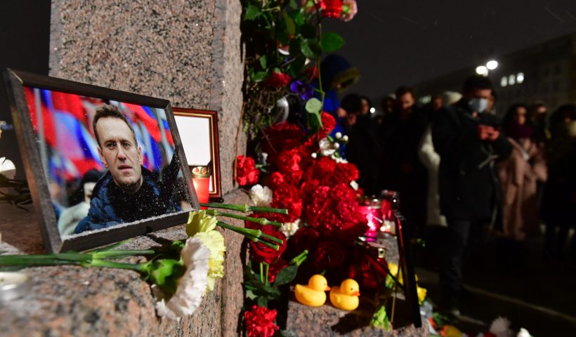 TOPSHOT - People gather at a makeshift memorial for late Russian opposition leader Alexei Navalny organized at the monument to the victims of political repressions in Saint Petersburg on February 16, 2024, following Navalny's death in his Arctic prison. (Photo by Olga MALTSEVA / AFP) (Photo by OLGA MALTSEVA/AFP via Getty Images)
