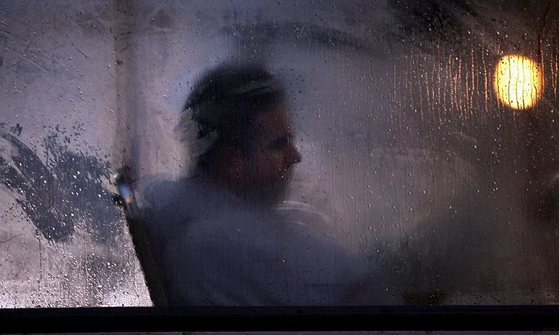 GLASGOW, UNITED KINGDOM - OCTOBER 10: A man makes his way home from work on a bus as darkness falls on October 10, 2005 in Glasgow, Scotland. Seasonal affective disorder (SAD), or winter depression, is a mood disorder related to the change in the seasons and the resulting reduction of exposure to daylight. The end of British Summer time, when clocks go back one hour at the end of October, will see most people making their daily commute in darkness both ways. With winter nights stretching to 19 hours in the UK, and Scotland's often inclement weather, it is estimated that the "Winter Blues" can affect up to 20% of the population. (Photo by Christopher Furlong/Getty Images)