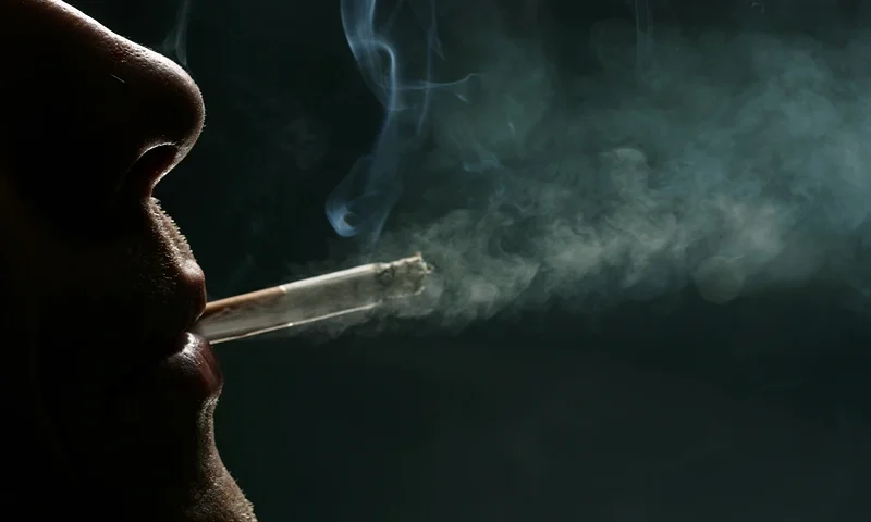 Countdown For Smoking Ban In England LONDON - MAY 16: In this photo illustration a man smokes a cigarette on May 16, 2007 in London. Businesses and shops are gearing up for the introduction of the smoking ban on July 1 in England after similar bans have been introduced in Ireland, Scotland and Wales. (Photo Illustration by Bruno Vincent/Getty Images)