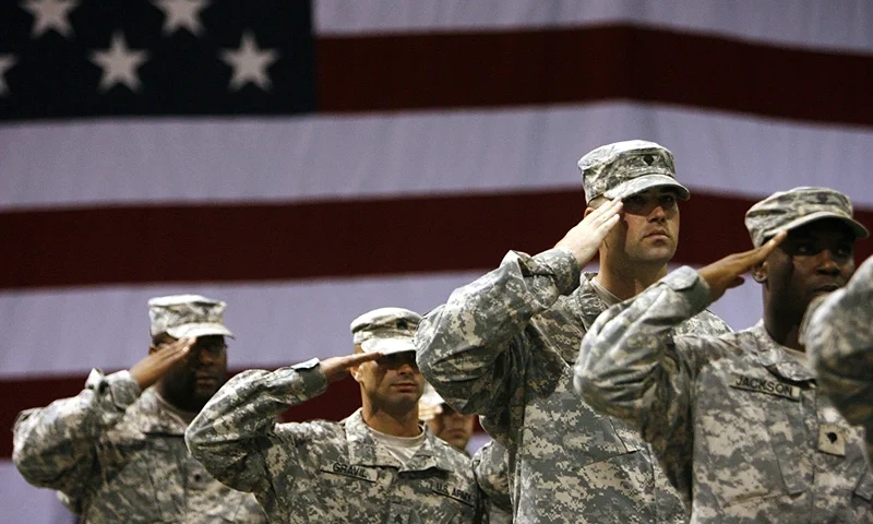 FORT RILEY, KS - SEPTEMBER 12: Soldiers stand saluting during the national anthem for the redeployment ceremony at Marshall Army Air Field inside hanger 727 for the 1st Battalion, 16th Infantry Regiment, 1st Brigade, 1st Infantry Division September 12, 2007 at Fort Riley, Kansas. The approximately 130 soldiers were returning after a one year tour in Iraq. (Photo by Larry W. Smith/Getty Images)