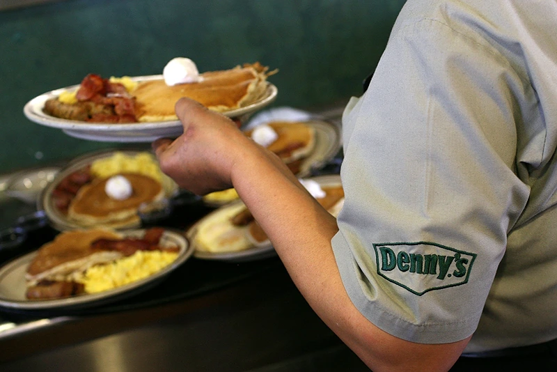 EMERYVILLE, CA - FEBRUARY 03: Denny's waitress Hirut Bizuneh prepares to deliver free Grand Slam breakfasts to customers February 3, 2009 in Emeryville, California. People lined up at Denny's across North America today for a free Grand Slam breakfast given away between 6am and 2pm at over 1,500 Denny's restaurants in the US, Puerto Rico and Canada. The promotion was announced during a Super Bowl commercial. (Photo by Justin Sullivan/Getty Images)
