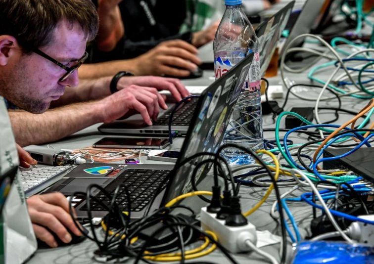 People work at computers during the 10th International Cybersecurity Forum in Lille on January 23, 2018. (Photo by Philippe HUGUEN / AFP) (Photo by PHILIPPE HUGUEN/AFP via Getty Images)