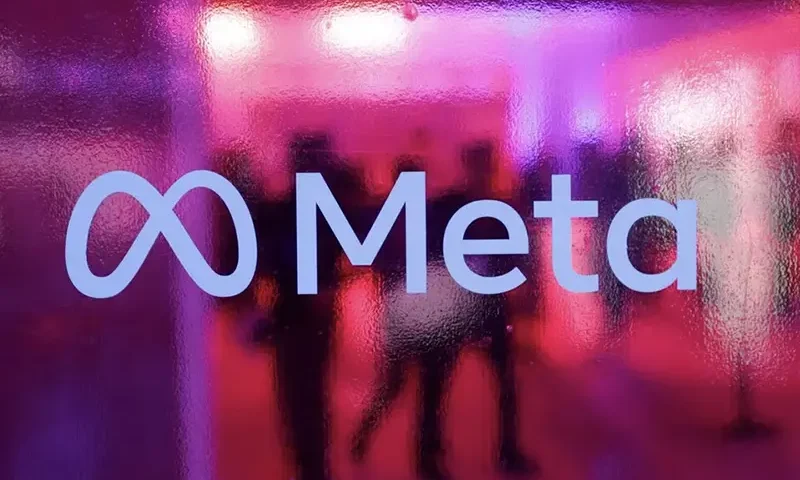 People walk behind a logo of Meta Platforms company, during a conference in Mumbai, India, September 20, 2023. REUTERS/Francis Mascarenhas/File Photo