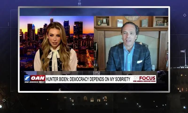 Video still from In Focus on One America News Network showing a split screen of the host on the left side, and on the right side is the guest, Harriet Hageman.