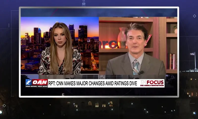 Video still from In Focus on One America News Network showing a split screen of the host on the left side, and on the right side is the guest, Eric Scheiner.