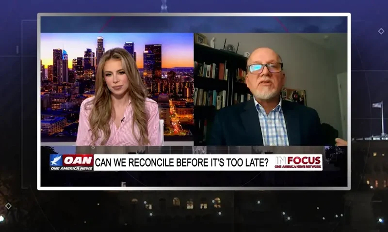 Video still from In Focus on One America News Network showing a split screen of the host on the left side, and on the right side is the guest, Leo Hohmann.