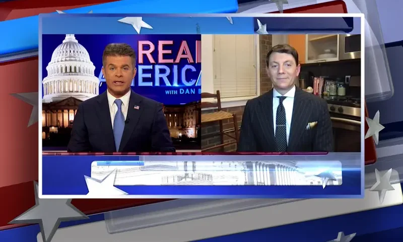 Video still from Real America on One America News Network showing a split screen of the host on the left side, and on the right side is the guest, Hogan Gidley.