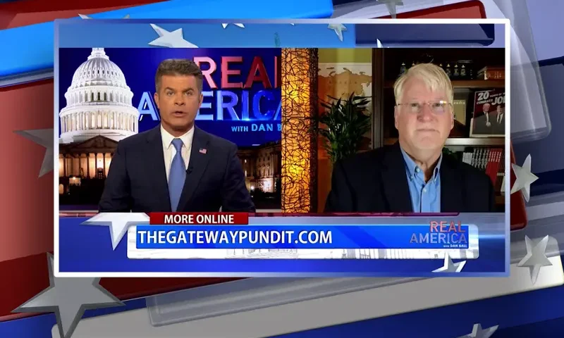 Video still from Real America on One America News Network showing a split screen of the host on the left side, and on the right side is the guest, Joe Hoft.