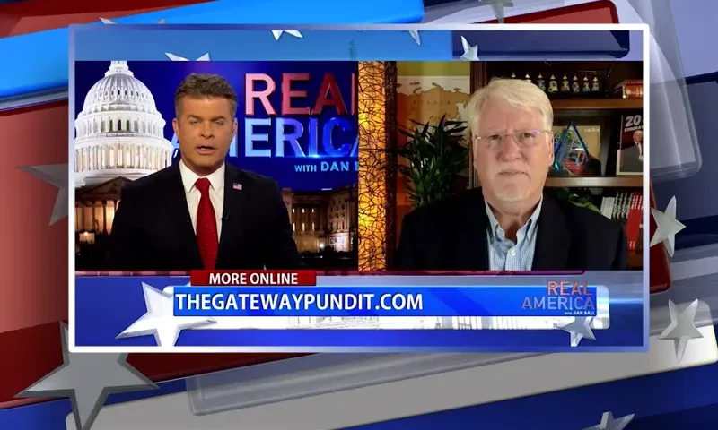Video still from Real America on One America News Network showing a split screen of the host on the left side, and on the right side is the guest, Joe Hoft.
