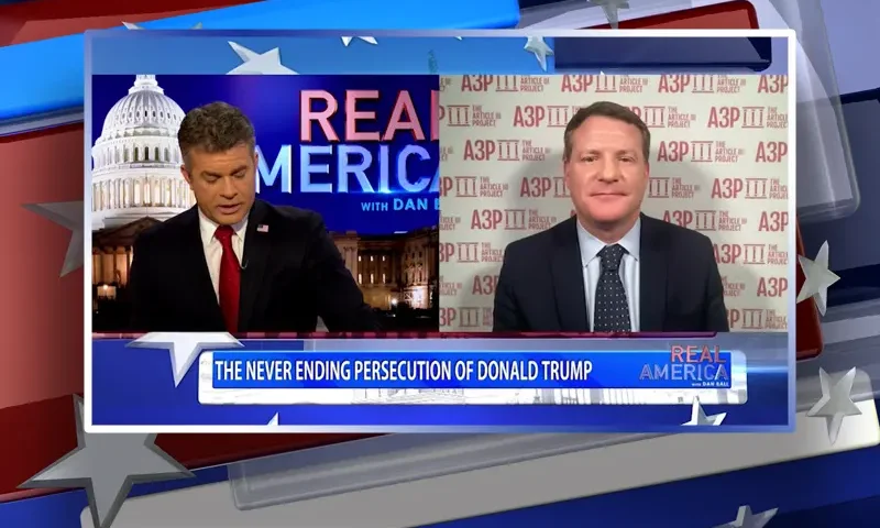 Video still from Real America on One America News Network showing a split screen of the host on the left side, and on the right side is the guest, Mike Davis.