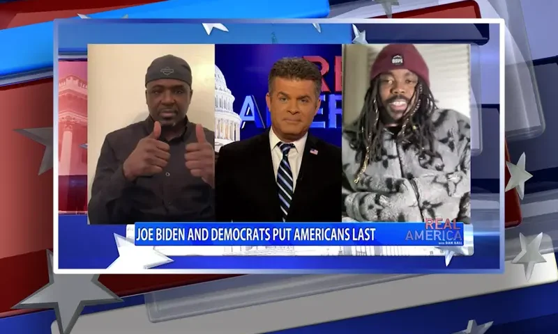 Video still from Real America on One America News Network during an interview with the guest, Dom Lucre and Mark Carter.