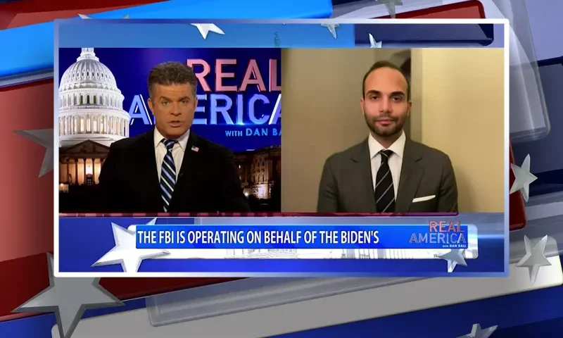 Video still from Real America on One America News Network showing a split screen of the host on the left side, and on the right side is the guest, George Papadopoulos.
