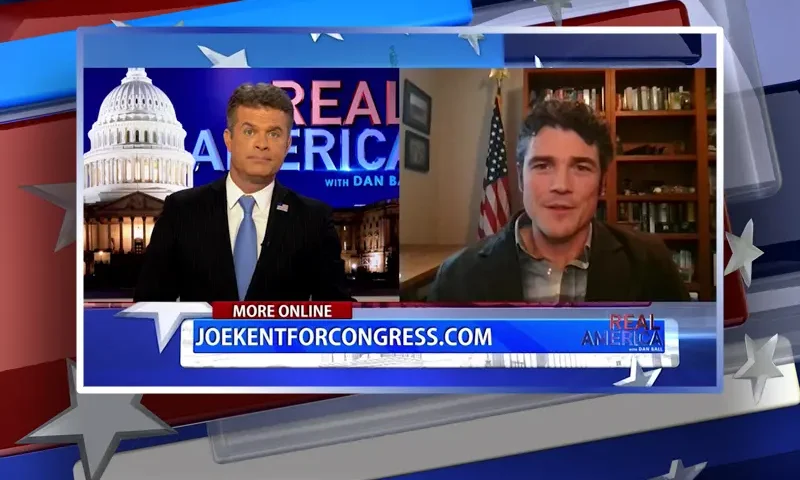 Video still from Real America on One America News Network showing a split screen of the host on the left side, and on the right side is the guest, Joe Kent.