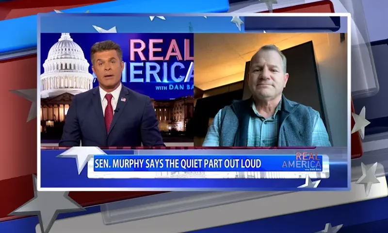Video still from Real America on One America News Network showing a split screen of the host on the left side, and on the right side is the guest, Rep. Troy Nehls.