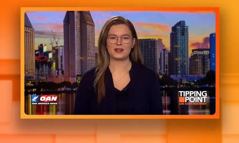 Video still of the host of Tipping Point at the desk of their talk show on One America News Network.
