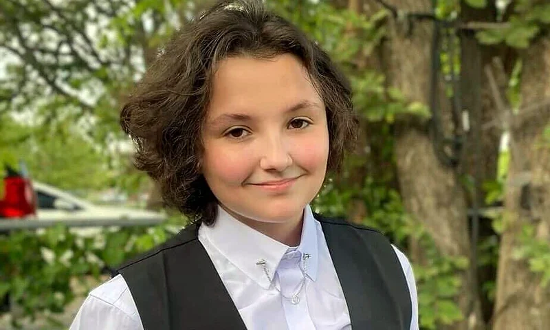 In this image provided Malia Pila, Nex Benedict poses outside the family’s home in Owasso, Okla., in December 2023. Police in Oklahoma are investigating the death of Benedict, a 16-year-old student who died a day after an altercation in a high school bathroom that may have been prompted by bullying over gender identity. Neither police nor school officials have said what led to the fight. But the family of Benedict says there had been harassment because the teen was nonbinary. (Sue Benedict via AP)
