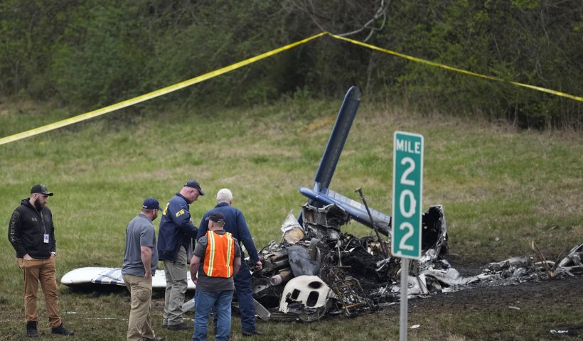 Investigators look over a small plane crash alongside eastbound Interstate 40 at mile marker 202 on Tuesday, March 5, 2024, in Nashville, Tenn. (AP Photo/George Walker IV)