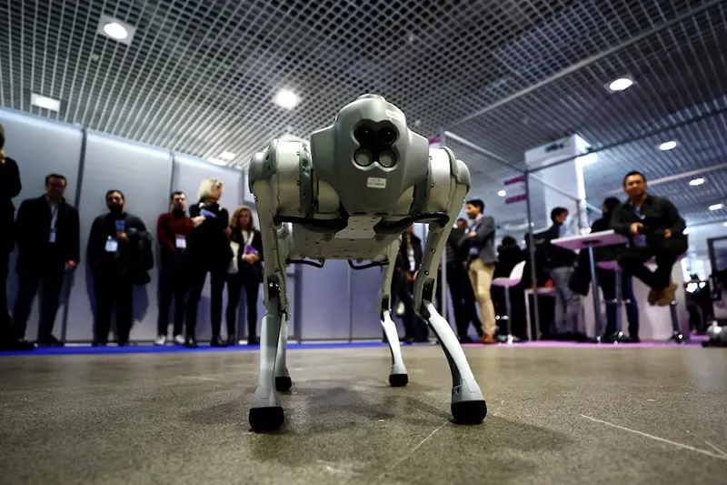Visitors look at a Go1 quadruped robot by Unitree Robotics during the World Artificial Intelligence Cannes Festival (WAICF) in Cannes, France, February 10, 2023. REUTERS/Eric Gaillard/File photo