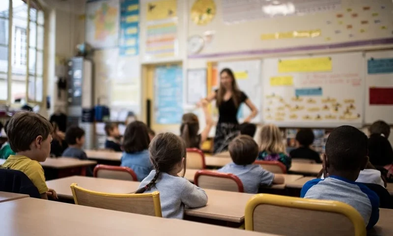 TOPSHOT - Children listen to their teacher as they sit in a classroom on the first day of the start of the school year, at the Chaptal elementary school in Paris, on September 2, 2019. In France some 12.4 million students crossed the doors of elementary schools (6.7 million), secondary school (3.4 million) and high schools (2.3 million) on September 2, 2019. (Photo by Martin BUREAU / AFP) (Photo by MARTIN BUREAU/AFP via Getty Images)