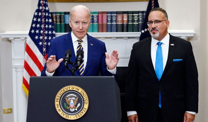 US President Joe Biden announces student loan relief with Education Secretary Miguel Cardona (R) on August 24, 2022 in the Roosevelt Room of the White House in Washington, DC. - Biden announced that most US university graduates still trying to pay off student loans will get $10,000 of relief to address a decades-old headache of massive educational debt across the country. (Photo by OLIVIER DOULIERY / AFP) (Photo by OLIVIER DOULIERY/AFP via Getty Images)