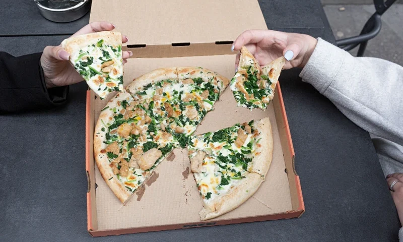 PARIS, FRANCE - JULY 09: Customers eat a robot-made pizza at Pazzi, Paris' first robotic pizzeria, on July 9, 2021 in Paris, France. The newly opened outlet is the company's second in France. The three-armed robot pizza chef – which currently costs €500,00 – can start a new order every 45 seconds and takes five minutes to make pizza from scratch.The market for service robots grew from $6.6 billion globally in 2017, to $37 billion in 2021 and is only expected to rise. (Photo by Sam Tarling/Getty Images)