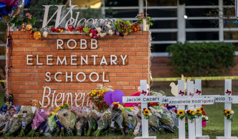 UVALDE, TEXAS - MAY 26: A memorial is seen surrounding the Robb Elementary School sign following the mass shooting at Robb Elementary School on May 26, 2022 in Uvalde, Texas. According to reports, 19 students and 2 adults were killed, with the gunman fatally shot by law enforcement. (Photo by Brandon Bell/Getty Images)