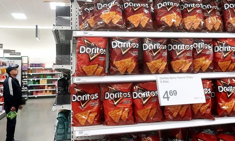 LOS ANGELES, CALIFORNIA - FEBRUARY 13: A person shops near a display of Doritos in a Target store on February 13, 2023 in Los Angeles, California. January's Consumer Price Index (CPI) will be released tomorrow showing the latest inflation data and providing perspective on possible future interest rate hikes by the Federal Reserve. (Photo by Mario Tama/Getty Images)