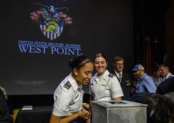 People look into a nearly 200-year-old time capsule during a ceremony in the Robinson Auditorium at Thayer Hall of the US Military Academy in West Point, New York, on August 28, 2023. The sealed lead time capsule measuring about one square foot was discovered in the Thaddeus Kosciuszko monument's base during recent renovations. Academy officials determined the capsule was placed in the base of the Kosciuszko monument 26 years after the academy's founding by cadets in 1828. The capsule was found to be mostly empty other than grey sediment. (Photo by Ed JONES / AFP) (Photo by ED JONES/AFP via Getty Images)