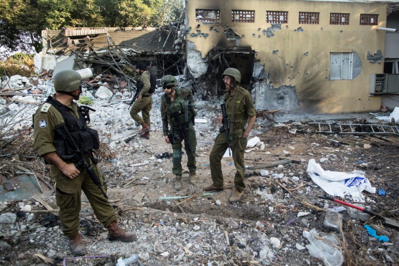 BE'ERI, ISRAEL - OCTOBER 14: Israeli soldiers inspect houses that were destroyed in a battle between Israeli soldiers and Palestinian militants on Saturday's Hamas attack on the kibbutz on on October 14, 2023 in Be'eri, Israel. Israel has sealed off Gaza and launched sustained retaliatory air strikes, which have killed at least 1,400 people with more than 400,000 displaced, after a large-scale attack by Hamas. On October 7, the Palestinian militant group Hamas launched a surprise attack on Israel from Gaza by land, sea, and air, killing over 1,300 people and wounding around 2,800. Israeli soldiers and civilians have also been taken hostage by Hamas and moved into Gaza. The attack prompted a declaration of war by Israeli Prime Minister Benjamin Netanyahu and the announcement of an emergency wartime government. (Photo by Amir Levy/Getty Images)