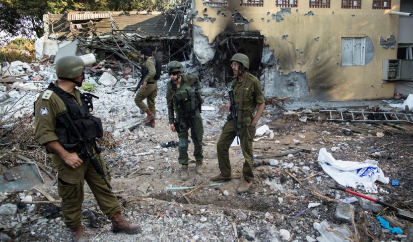 BE'ERI, ISRAEL - OCTOBER 14: Israeli soldiers inspect houses that were destroyed in a battle between Israeli soldiers and Palestinian militants on Saturday's Hamas attack on the kibbutz on on October 14, 2023 in Be'eri, Israel. Israel has sealed off Gaza and launched sustained retaliatory air strikes, which have killed at least 1,400 people with more than 400,000 displaced, after a large-scale attack by Hamas. On October 7, the Palestinian militant group Hamas launched a surprise attack on Israel from Gaza by land, sea, and air, killing over 1,300 people and wounding around 2,800. Israeli soldiers and civilians have also been taken hostage by Hamas and moved into Gaza. The attack prompted a declaration of war by Israeli Prime Minister Benjamin Netanyahu and the announcement of an emergency wartime government. (Photo by Amir Levy/Getty Images)