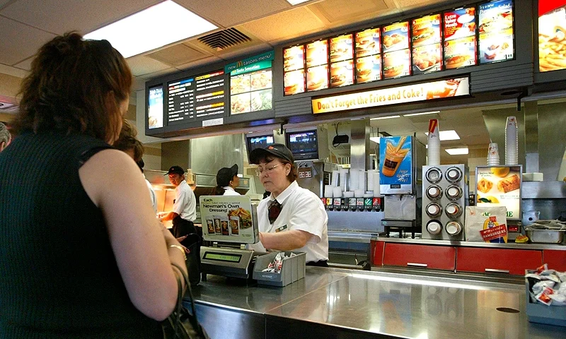 NILES, ILLINOIS - APRIL 30: People stand at a counter inside a McDonald's fast food restaurant April 30, 2003 in Niles, Illinois. McDonald's Corporation announced that results for the quarter that ended March 31 and showed a 7 percent gain in earnings per share (before the cumulative effect of accounting changes) on higher revenues. Comparable unit sales have declined. (Photo by Tim Boyle/Getty Images)