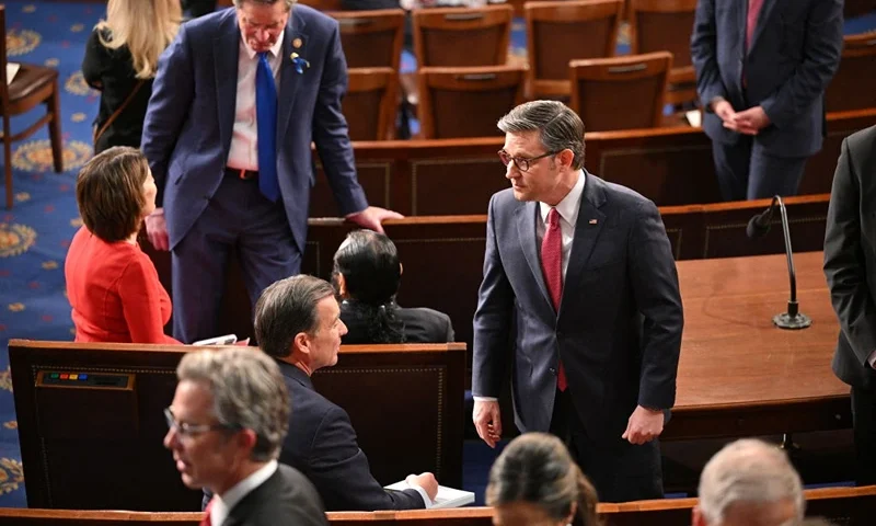Speaker of the House Mike Johnson (C) arrives on the floor of the House of Representatives ahead of US President Joe Biden's the State of the Union address in the House Chamber of the US Capitol in Washington, DC, on March 7, 2024. (Photo by Mandel NGAN / AFP) (Photo by MANDEL NGAN/AFP via Getty Images)