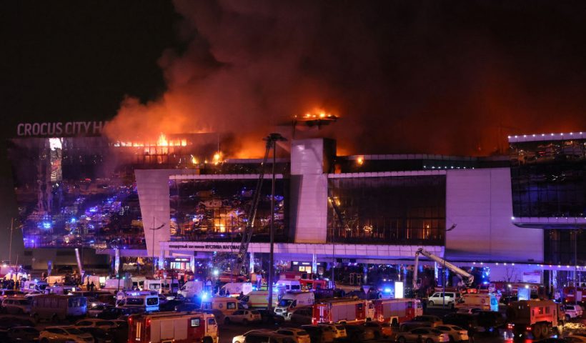 Emergency services vehicles are seen outside the burning Crocus City Hall concert hall following the shooting incident in Krasnogorsk, outside Moscow, on March 22, 2024. Gunmen opened fire at a concert hall in a Moscow suburb on March 22, 2024 leaving dead and wounded before a major fire spread through the building, Moscow's mayor and Russian news agencies reported. (Photo by STRINGER / AFP) (Photo by STRINGER/AFP via Getty Images)