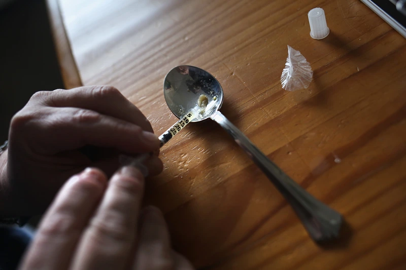 New England Towns Struggle With Opioid And Heroin Epidemic
NEW LONDON, CT - MARCH 23: A heroin user prepares to inject himself on March 23, 2016 in New London, CT. Communities nationwide are struggling with the unprecidented heroin and opioid pain pill epidemic. On March 15, the U.S. Centers for Disease Control (CDC), announced guidelines for doctors to reduce the amount of opioid painkillers prescribed nationwide, in an effort to curb the epidemic. The CDC estimates that most new heroin addicts first became hooked on prescription pain medication before graduating to heroin, which is stronger and cheaper. (Photo by John Moore/Getty Images)