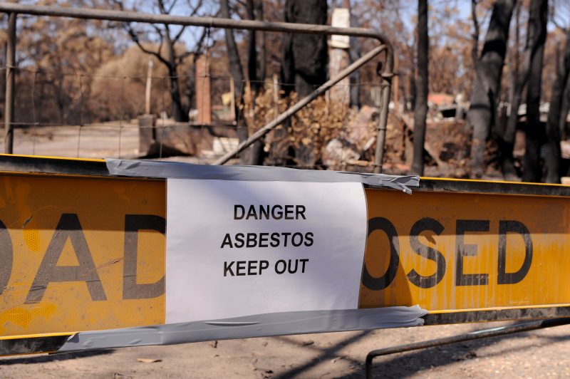 WONDONG, AUSTRALIA - FEBRUARY 19: A sign warns of the dangers of asbestos at a burnt out property in the Wondong region on February 19, 2009 in Wondong, Australia. Victoria Police have revised the bushfire disaster death toll to over 200, the worst in Australia's history. (Photo by Robert Cianflone/Getty Images)