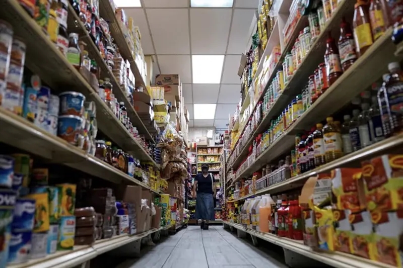 A woman shops for groceries at El Progreso Market in the Mount Pleasant neighborhood of Washington, D.C., U.S., August 19, 2022. REUTERS/Sarah Silbiger/File Photo