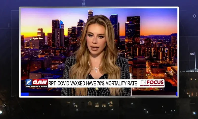 Video still of the host of In Focus at the desk of their talk show on One America News Network.